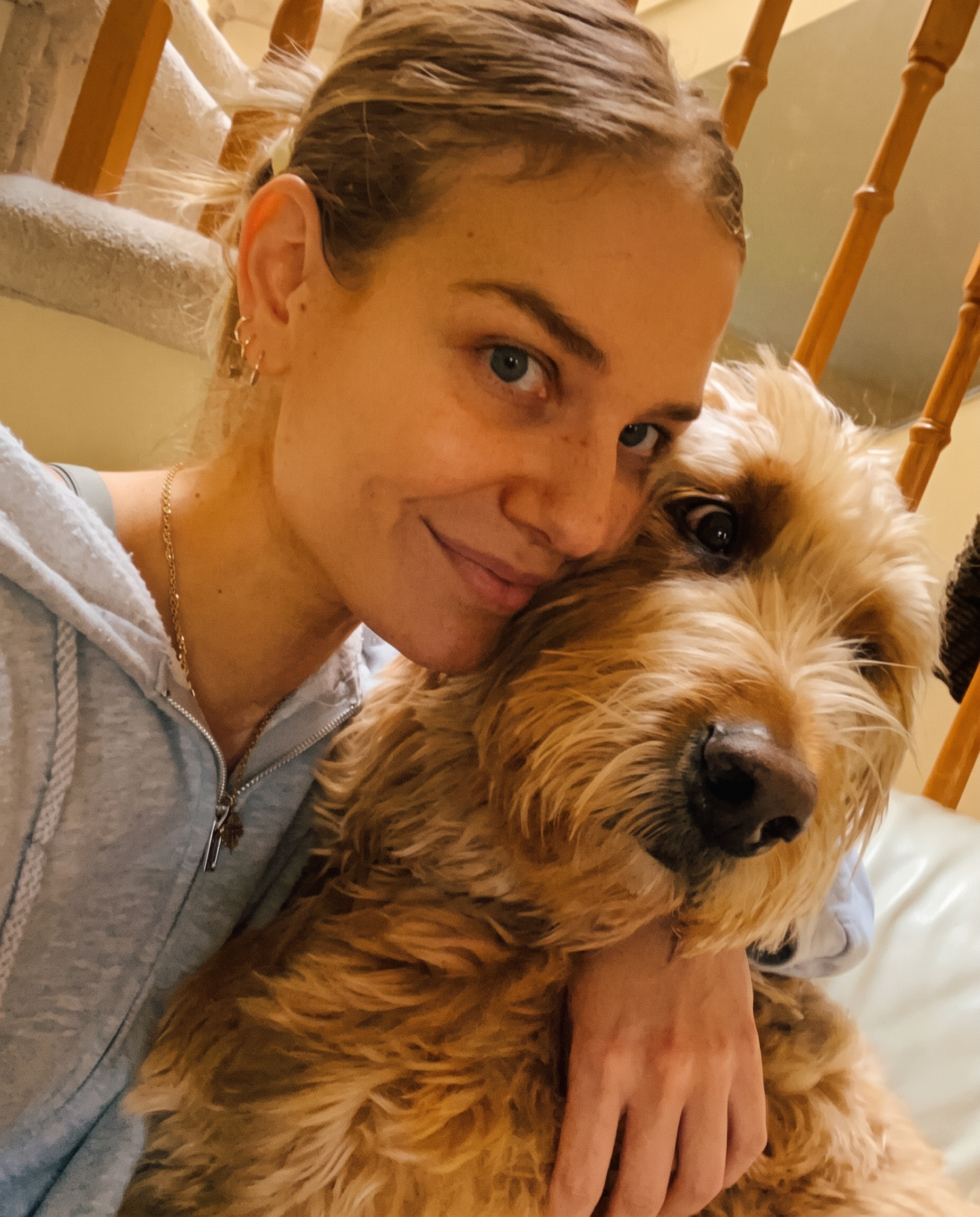 Anna cuddling her dog Koba